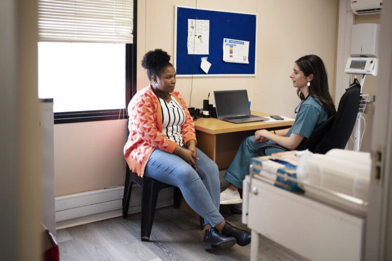 A doctor and patient talking in an office visit